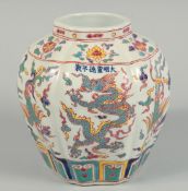 A CHINESE OCTAGONAL VASE decorated with dragons 7.5ins high.
