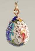 A SILVER AND ENAMEL EGG PENDANT.