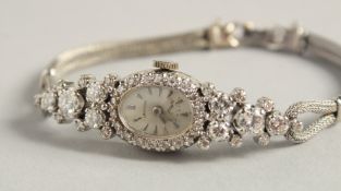 A LADIES’ CROTON DIAMOND SET COCKTAIL WATCH with 14k Cartier bracelet.