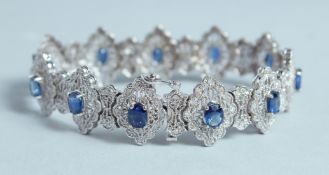 A GOOD WHITE GOLD DIAMOND AND SAPPHIRE BRACELET set with eleven sapphires.