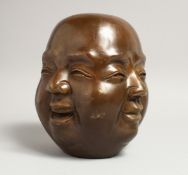 A LARGE CHINESE BRONZE FOUR FACED BUDDHA HEAD. 7.5ins high.