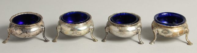 A SET OF FOUR VICTORIAN CIRCULAR SALTS with sapphire blue liners on three pad feet. Edinburgh 1862.