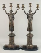 A GOOD PAIR OF LARGE BRONZE EMPIRE TWO BRANCH CANDLESTICKS, held by classical figures on circular