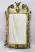 A GOOD GEORGE III DESIGN CARVED WOOD AND GILDED MIRROR with acanthus scrolls, masks, and urns. 3ft