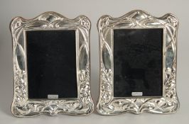 A PAIR OF SILVER PHOTOGRAPH FRAMES. 7ins high.