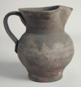 AN EARLY POTTERY JUG. 6ins.