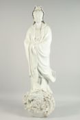 A LARGE CHINESE WHITE PORCELAIN STANDING GUANYIN FIGURE. 3ft high.