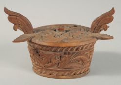 A SMALL SCANDINAVIAN WOODEN OVAL BOX AND COVER. 5ins long.