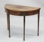 A GOOD GEORGE III MAHOGANY DEMI-LUNE FOLD OVER CARD TABLE with tapering legs. 2ft 6ins high x 3ft