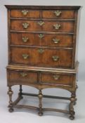 AN EARLY 17TH CENTURY CHEST ON STAND with a moulded cornice above two short and three graduated long