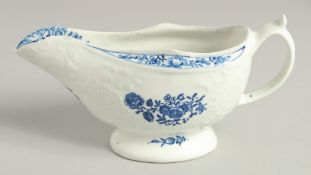AN 18TH CENTURY LOWESTOFT MOULDED SAUCE BOAT printed with flowers, the border painted in