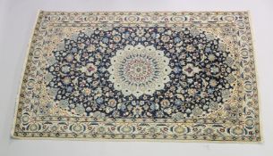 A PERSIAN RUG blue ground with central loral medallion within a cream ground floral border. 6ft 6ins
