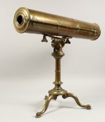 A 19TH CENTURY BRASS TELESCOPE on a tripod base.