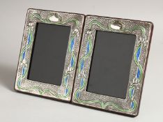 A PAIR OF SILVER AND ENAMEL PHOTOGRAPH FRAMES 7.5ins x 5.5ins.