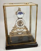 A GOOD BRASS AND ENAMEL MOONFACE SKELETON CLOCK surrounded by an eagle. 17ins high in a glass