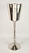 A BOLLINGER ICE BUCKET ON STAND.