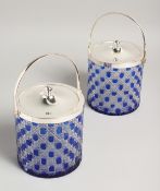 A PAIR OF BLUE OVERLAY CUT GLASS BISCUIT BARRELS with plated lid and handles.
