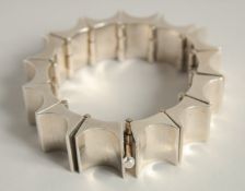 A MODERNIST SILVER BANGLE.