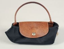 A LONGCHAMP FOLDING TOTE BAG. 7ins x 3.5 with two handles.