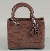 A CHRISTIAN DIOR BROWN LEATHER HANDBAG. No. 43 88 4011949 147. 9.25ins x 7.5ins.