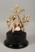 A LARGE CORAL SPECIMEN on a wooden stand. 9ins long.