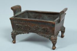 A CHINESE BRONZE TWO HANDLED RECTANGULAR CENSER 3.5ins long