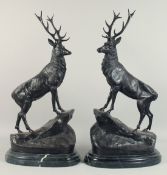 AFTER JULES MOIGNIEZ. A LARGE PAIR OF STAGS standing on a rock. Signed. 2ft 4ins high including