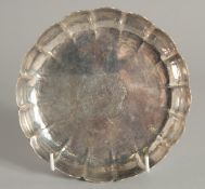 A QUEEN ANNE CIRCULAR STRAWBERRY DISH with crest. 6.25ins diameter. 1ins deep. Dublin 1708. Maker