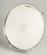 A SUPERB GEORGE III CIRCULAR SALVER by HESTER BATEMAN with bead edge on four curving feet, with
