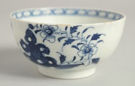 AN 18TH CENTURY LOWESTOFT SMALL BOWL painted with holed rock and chrysanthemum.