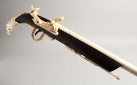 A GOOD CARVED BONE GUN WALKING STICK. 36ins long.