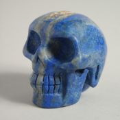 A CARVED LAPIS SKULL. 2ins high.