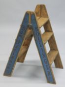 A NOVELTY PAIR OF BLUE FOLDING WOODEN STEPS.