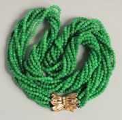 A VERY GOOD MULTI STRAND JADE NECKLACE with gold and diamond clasp.