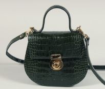 A SAGE BROWN - GREEN CROCODILE BAG. 7.25ins x 7.5ins with handles and long leather straps.