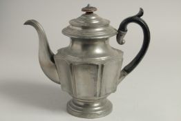 A PEWTER COFFEE POT AND COVER with wooden handles. 9ins high.