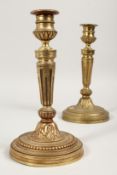 A GOOD PAIR OF LOUIS XVI ORMOLU CANDLESTICKS on circular bases. 9ins high.