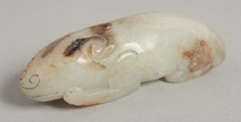 A CARVED WHITE JADE DOG.