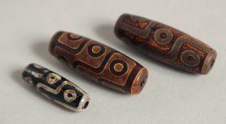 THREE AGATE DZI BEADS.