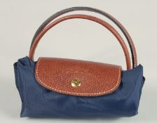 A LONGCHAMP FOLDING TOTE BAG. 7ins x 3.5 with two handles.