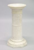 A MARBLE COLUMN with circular top and octagonal base 27ins high.