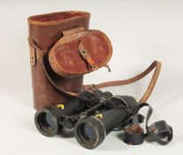 A BARR & STROUD of GLASGOW LONDON NAVAL BINOCULARS, with leather case. 9.5ins long.