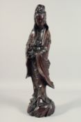 A 19TH CENTURY CHINESE ROSEWOOD SILVER INLAID GUANYIN FIGURE. 24ins high.