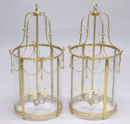 A PAIR OF GEORGIAN STYLE BRASS AND GLASS CIRCULAR HALL LANTERNS. 2ft 8ins high.