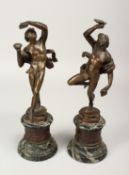 AFTER THE ANTIQUE. A GOOD PAIR OF 19TH CENTURY BRONZES OF DANCING CLASSICAL FIGURES on circular