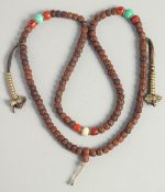 A CHINESE CINNABAR NECKLACE.