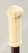 A WALKING STICK with carved bone handle 'BASKET'. 2ft 11ins long.