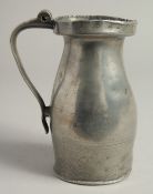 AN 18TH CENTURY PEWTER JUG 7ins high