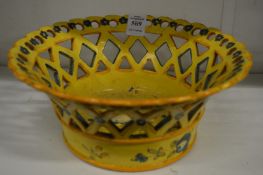 A continental yellow ground pottery pierced basket form dish.