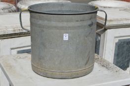 A galvanised twin handled planter.